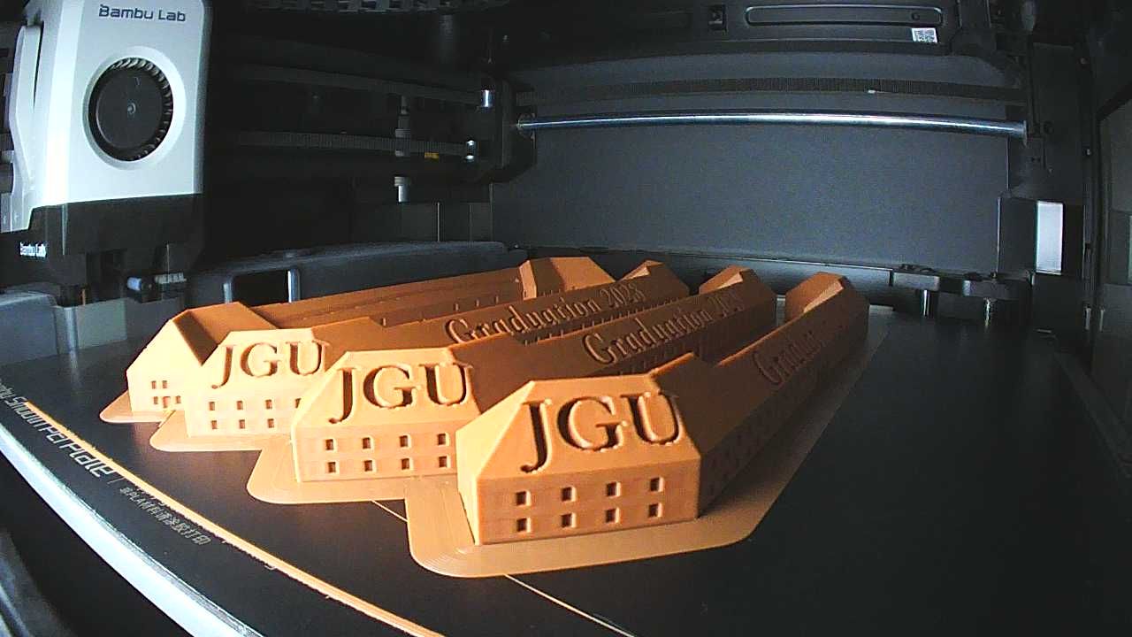 A real camera frame: four cleanly printed buildings with years on the roofs