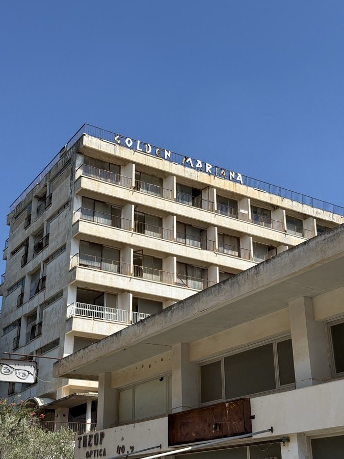 The abandoned Golden Mariana hotel, five floors of empty balconies under a hard blue sky